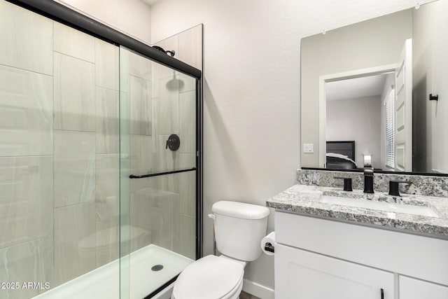 ensuite bathroom featuring a stall shower, ensuite bath, vanity, and toilet