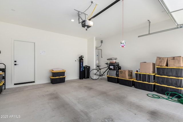 garage featuring a garage door opener and water heater