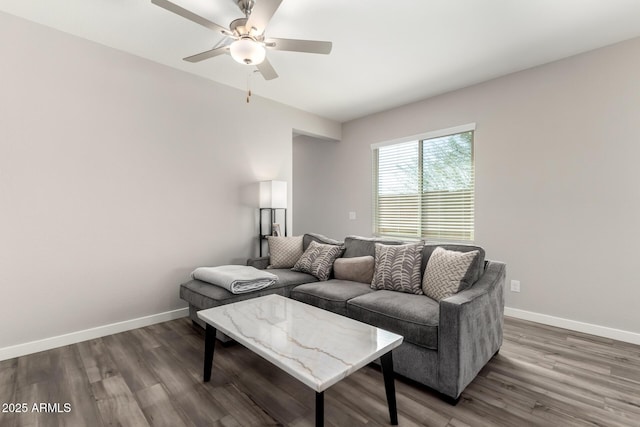 living room featuring wood finished floors, a ceiling fan, and baseboards