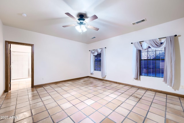 empty room featuring ceiling fan, visible vents, baseboards, and light tile patterned flooring