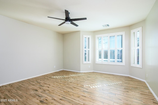 42531 W Heavenly Pl, Maricopa, AZ 85138 - empty room featuring a ceiling fan, wood finished floors, visible vents, and baseboards