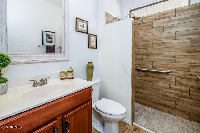 42531 W Heavenly Pl, Maricopa, AZ 85138 - bathroom featuring tiled shower, vanity, toilet, and wood finished floors