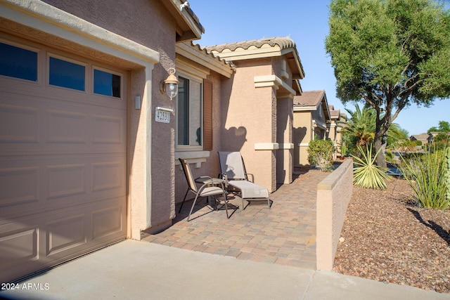 42531 W Heavenly Pl, Maricopa, AZ 85138 - view of side of property featuring a garage, a tiled roof, and stucco siding