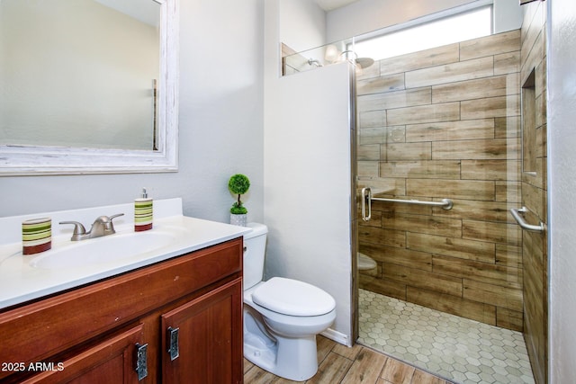 42531 W Heavenly Pl, Maricopa, AZ 85138 - bathroom featuring vanity, wood finished floors, a shower stall, and toilet
