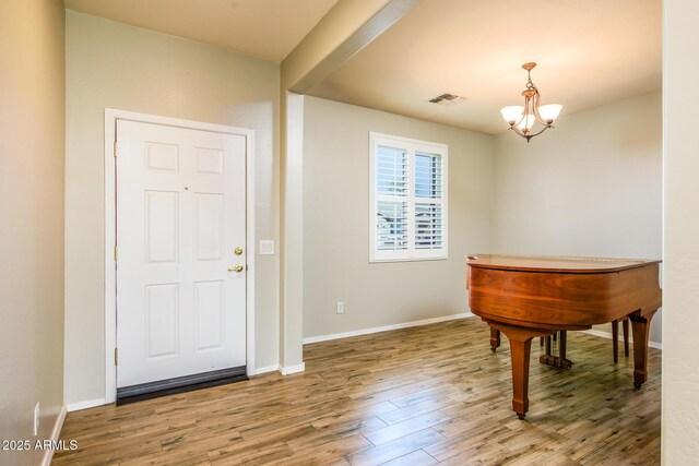 42531 W Heavenly Pl, Maricopa, AZ 85138 - entrance foyer featuring baseboards, visible vents, an inviting chandelier, and wood finished floors