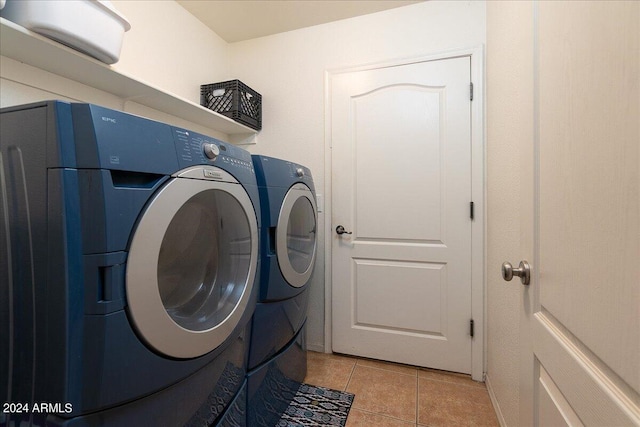 clothes washing area featuring independent washer and dryer and light tile patterned floors