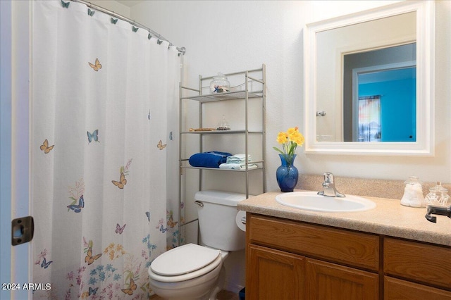 bathroom featuring walk in shower, toilet, and vanity