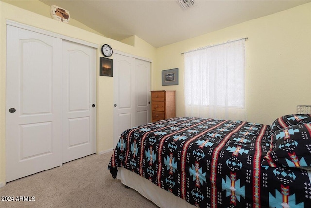 carpeted bedroom featuring lofted ceiling