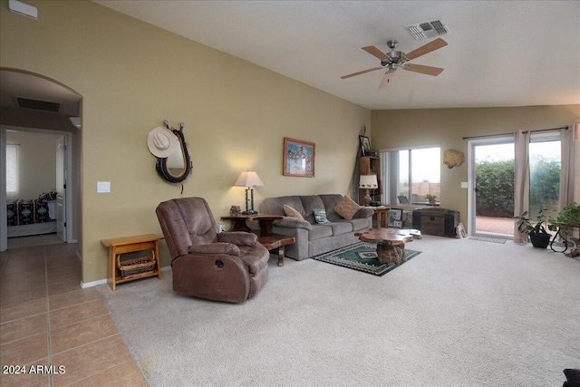 living room featuring vaulted ceiling, ceiling fan, and carpet