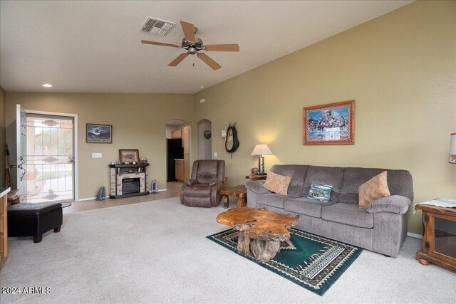 living room featuring lofted ceiling, ceiling fan, and carpet