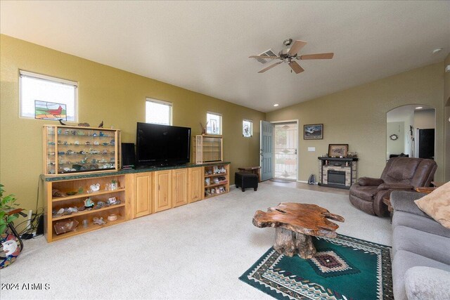 living room featuring lofted ceiling, ceiling fan, plenty of natural light, and carpet