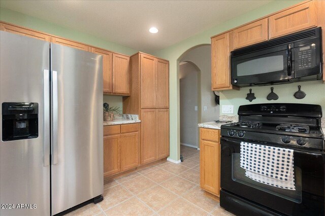 kitchen featuring black appliances and light tile patterned floors