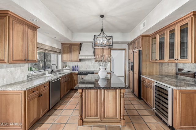 kitchen with sink, stainless steel appliances, a center island, custom exhaust hood, and beverage cooler