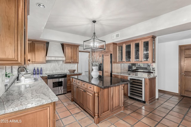 kitchen featuring sink, stainless steel electric range, a center island, wine cooler, and custom range hood