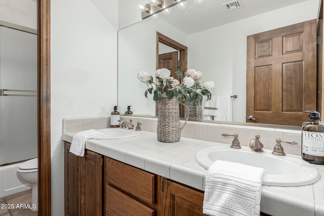 bathroom with vanity and toilet