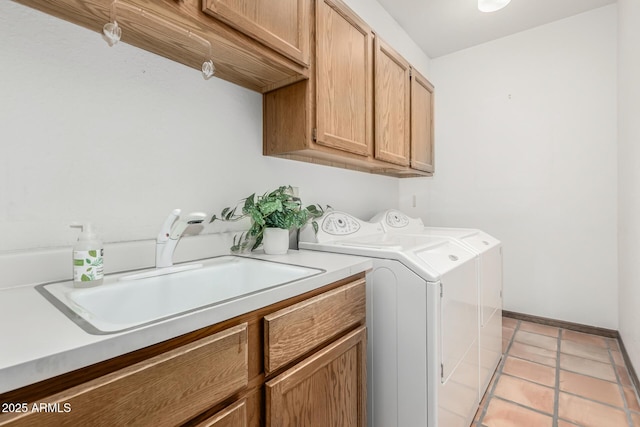 washroom with cabinets, washer and clothes dryer, sink, and light tile patterned floors