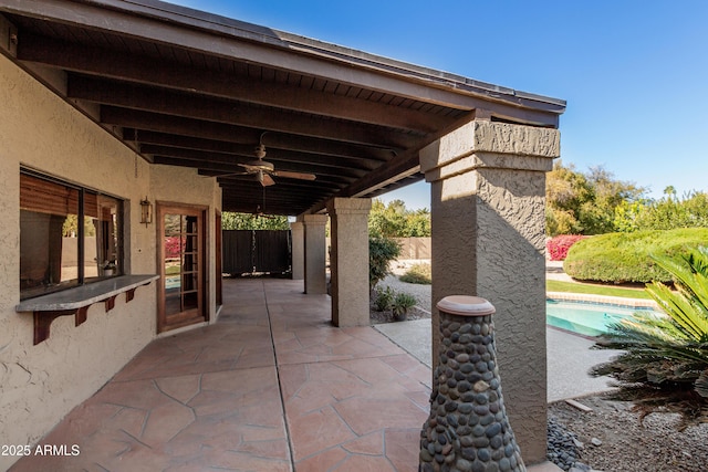 view of patio / terrace with ceiling fan and a fenced in pool