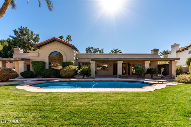 back of house featuring a yard and a patio area