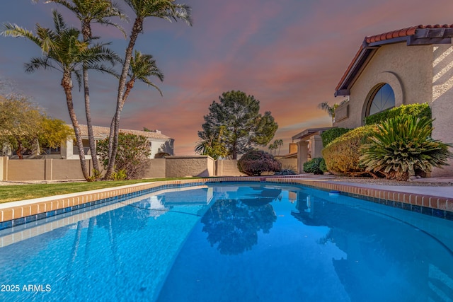 view of pool at dusk