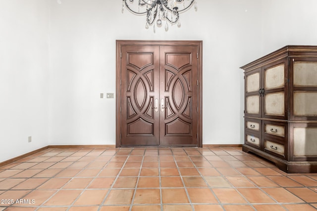 foyer entrance featuring a notable chandelier and light tile patterned floors