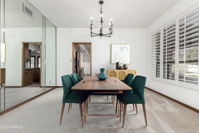 carpeted dining space with a chandelier