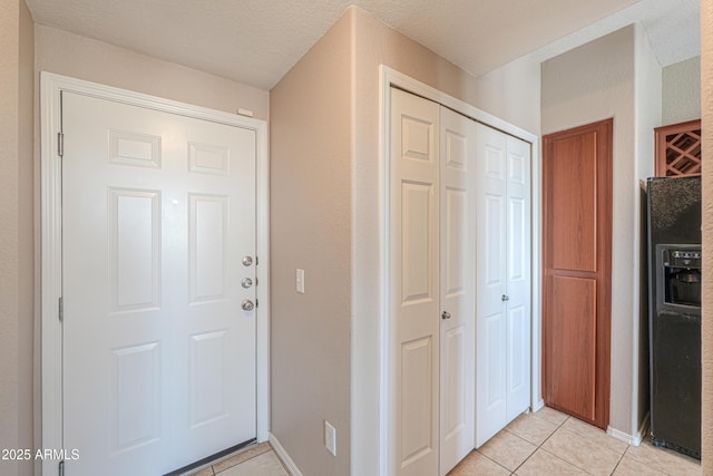9820 N Central Ave Unit 212, Phoenix, AZ 85020 - foyer with light tile patterned floors and baseboards