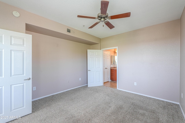 9820 N Central Ave Unit 212, Phoenix, AZ 85020 - unfurnished bedroom featuring light colored carpet, connected bathroom, and a ceiling fan