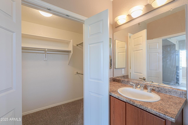 9820 N Central Ave Unit 212, Phoenix, AZ 85020 - bathroom featuring vanity and a walk in closet