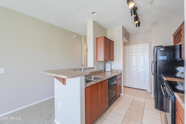 9820 N Central Ave Unit 212, Phoenix, AZ 85020 - kitchen with black appliances, brown cabinets, a peninsula, and a textured ceiling