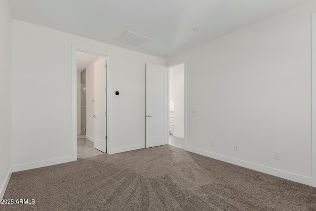 unfurnished bedroom featuring carpet and baseboards