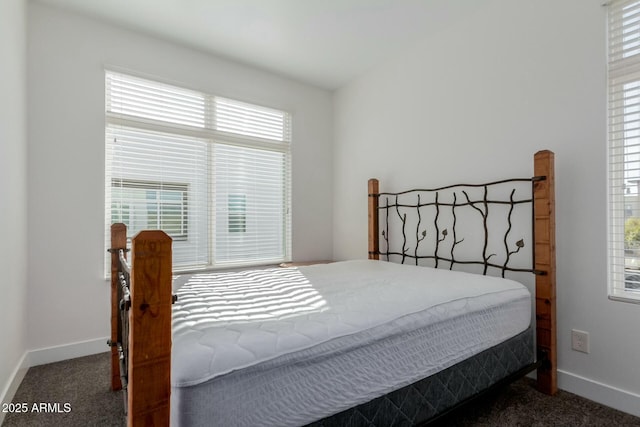 bedroom featuring carpet and baseboards