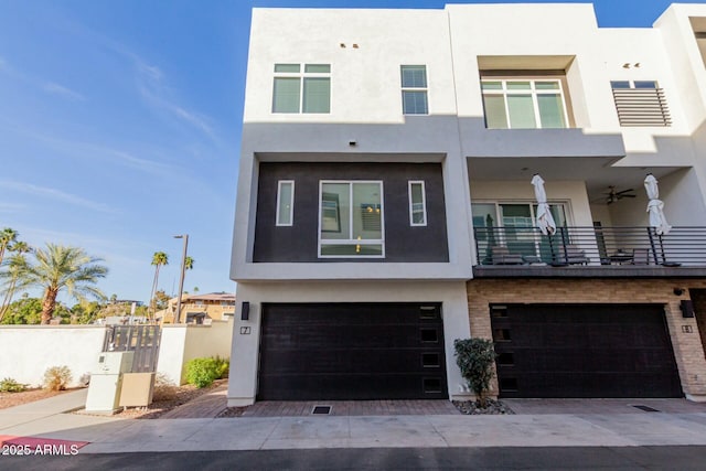 view of front of property featuring a garage, decorative driveway, and stucco siding