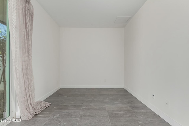 unfurnished room featuring baseboards