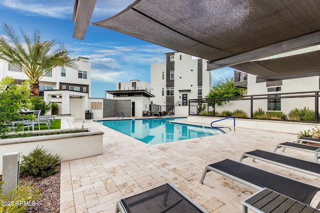 pool featuring fence and a patio