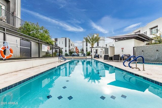 community pool with a patio area and a residential view