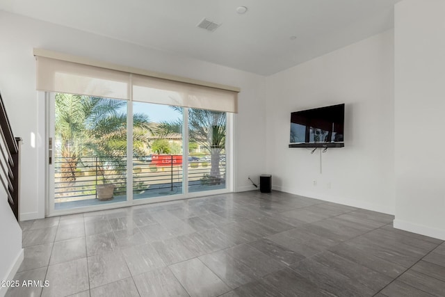 unfurnished living room featuring visible vents and baseboards