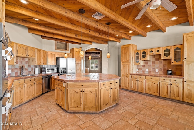 kitchen featuring tile countertops, stainless steel appliances, a sink, visible vents, and wood ceiling