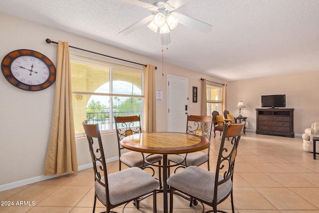 dining area featuring ceiling fan, a textured ceiling, and light tile patterned floors