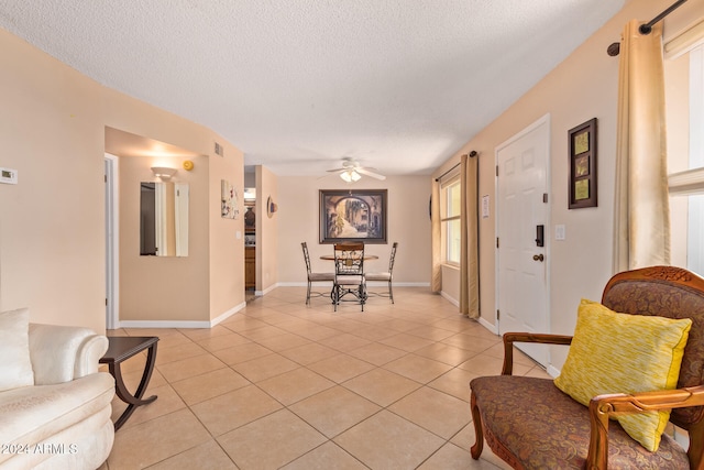 interior space featuring a textured ceiling and ceiling fan