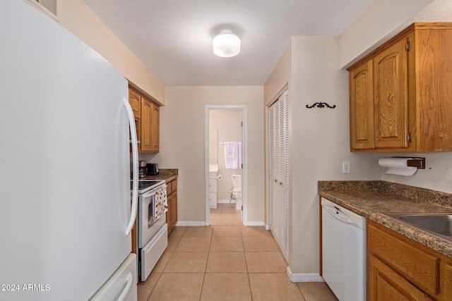 kitchen with light tile patterned flooring and white appliances