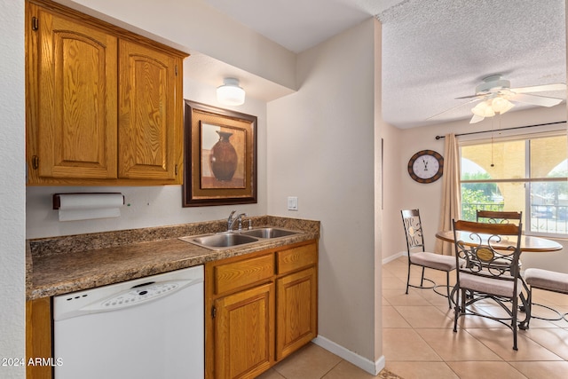 kitchen featuring light tile patterned flooring, sink, ceiling fan, a textured ceiling, and dishwasher