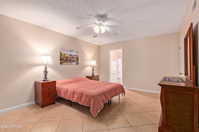 tiled bedroom with a textured ceiling, ceiling fan, and ensuite bathroom