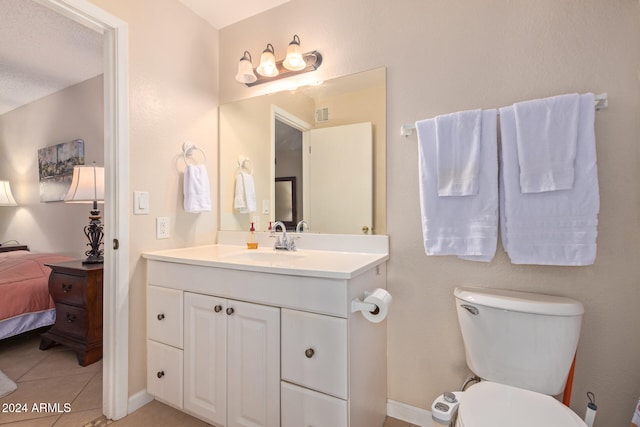 bathroom with vanity, tile patterned flooring, toilet, and a textured ceiling