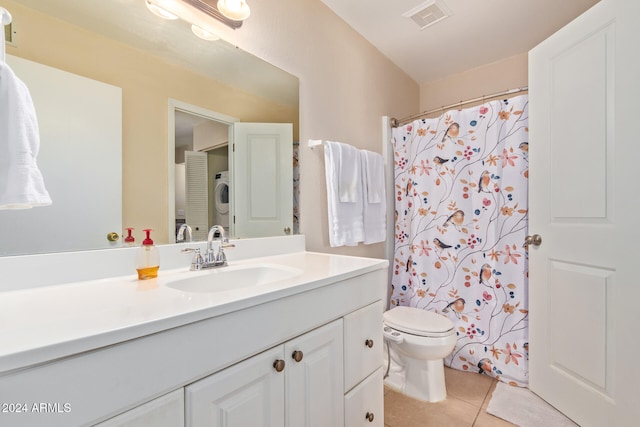 bathroom featuring tile patterned flooring, vanity, toilet, and stacked washer and clothes dryer