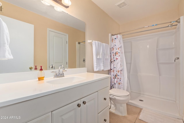 bathroom featuring toilet, vanity, tile patterned floors, and a shower with curtain