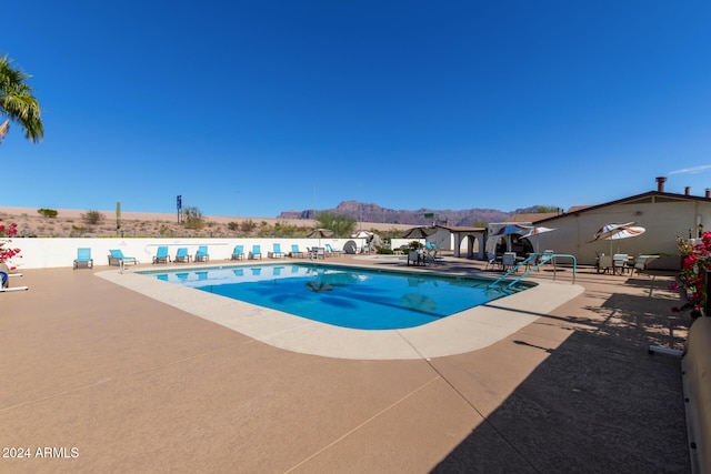 view of pool featuring a patio area and a mountain view