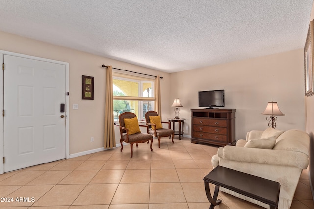 living room featuring a textured ceiling and light tile patterned floors