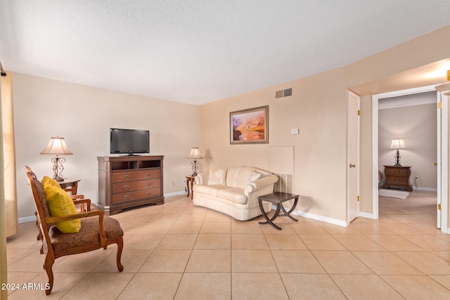 tiled living room with a textured ceiling