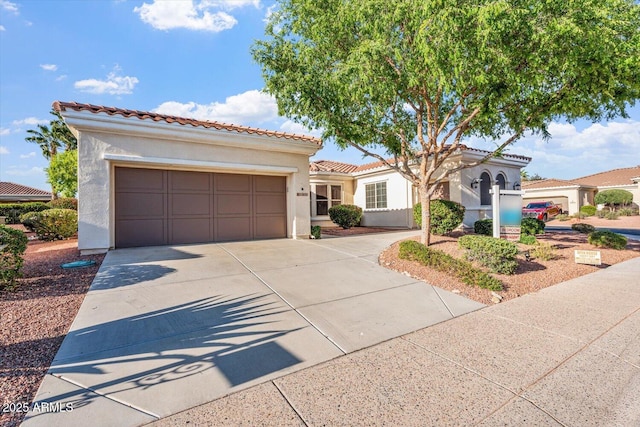 12820 W La Vina Dr, Sun City West, AZ 85375 - mediterranean / spanish-style home featuring an attached garage, a tiled roof, driveway, and stucco siding