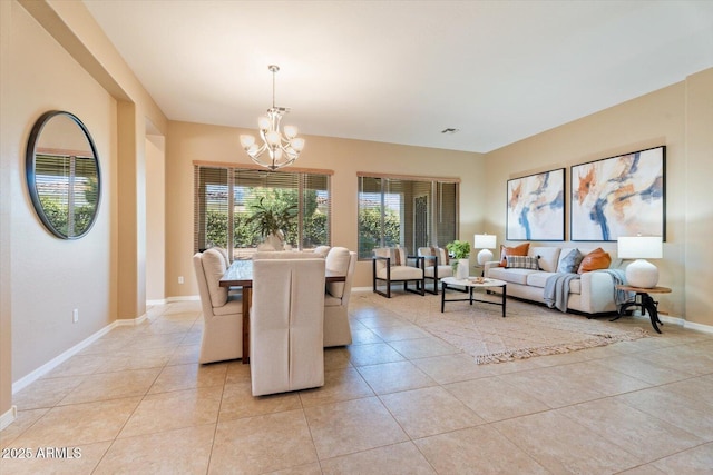 12820 W La Vina Dr, Sun City West, AZ 85375 - dining area with baseboards, a notable chandelier, and light tile patterned floors